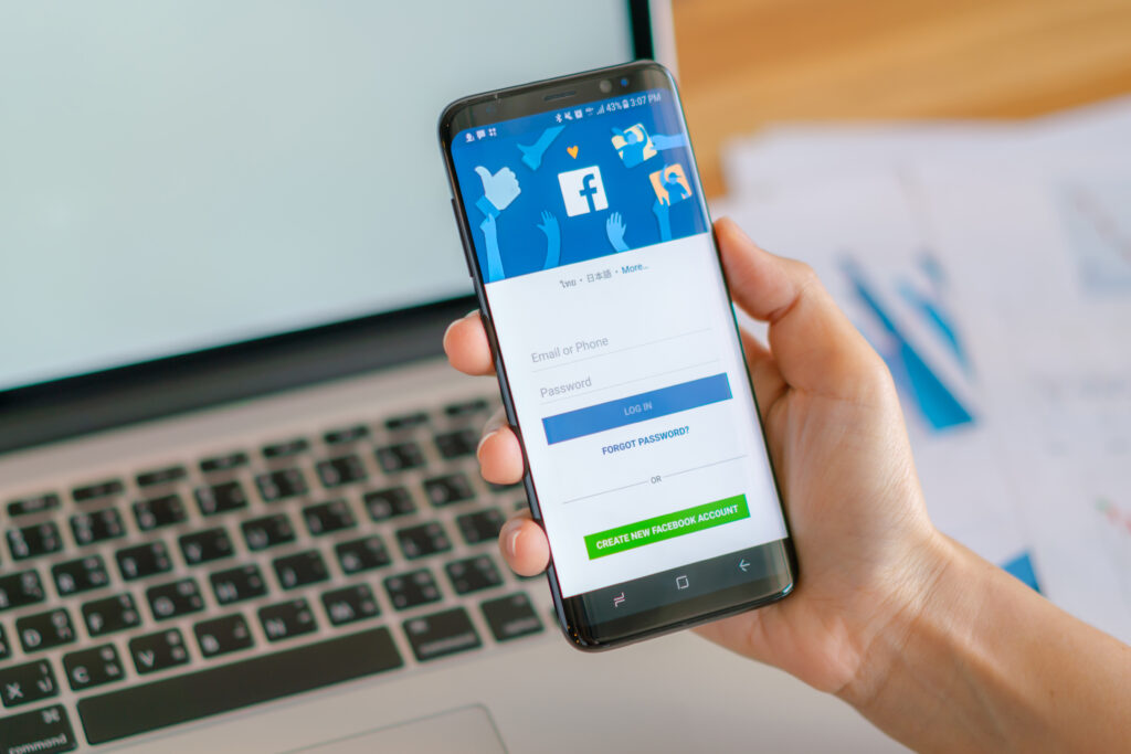 Loei, Thailand - May 10, 2017: Hand holding samsung s8 with mobile application for Facebook on the screen